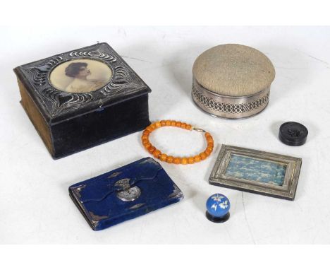 An Art Nouveau silver clad jewellery box, the hinged cover with a circular portrait print of a lady within a silver surround,