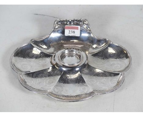 A Victorian silver desk stand, of scalloped shell shape with central circular inkwell recess (lacking inkwell) and further ch