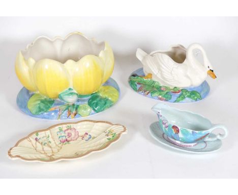 A Clarice Cliff pottery table centrepiece in the form of a swan, on a naturalistic base, printed Wilkinson marks to the under