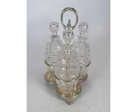 A 19th century Old Sheffield plate bottle cruet of treffoil shape, containing three cut glass decanters of ovoid shape, heigh