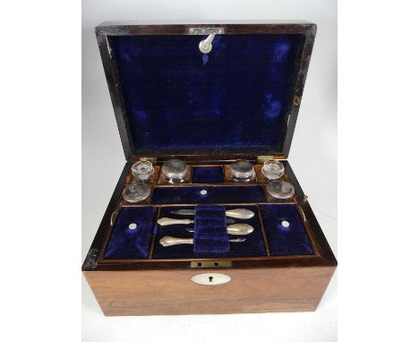 A 19th century rosewood vanity case, the hinged lid with vacant mother of pearl cartouche, opening to reveal fitted interior 