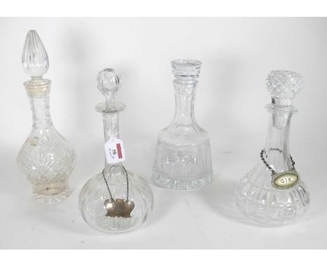 A group of four glass decanters, to include a cut glass example of mallet shape, height 26cm, and a Caithness example, togeth