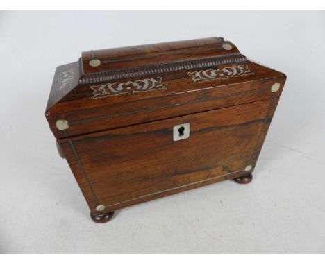 A William IV rosewood and mother of pearl inlaid  tea caddy of sarcophagus form opening to reveal a twin compartment interior