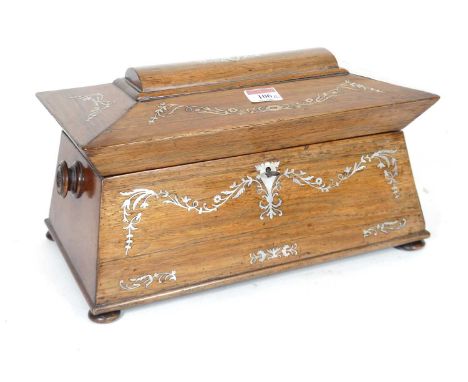 A mid 19th century rosewood and mother of pearl inlaid tea caddy of sarcophagus shape, the hinge lid opening to reveal a twin