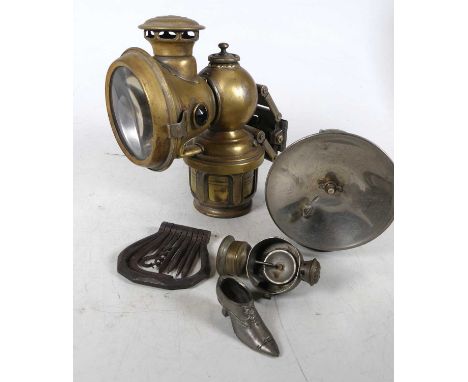 An early 20th century Lucas bicycle light, together with another, a metal pin cushion in the form of a shoe and a multitool (