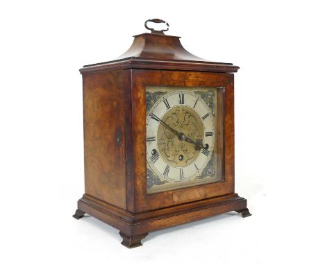 A Mappin &amp; Webb reproduction walnut cased table clock, surmounted by a handle, the brass dial with applied silvered chapt