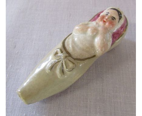 Novelty ceramic whistle in the form of a baby in a shoe L 7.5 cm