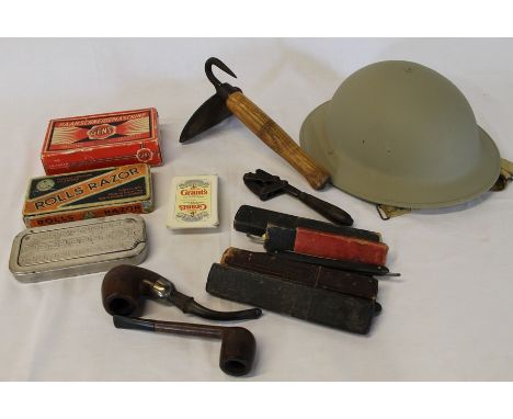 Selection of cut throat razors, 1954 army helmet, pig scraper, American spanner etc.