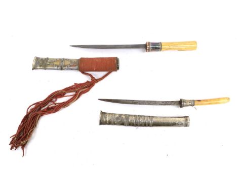 A 19th Century Burmese Dha Knife, with 22.5cm single edge slightly curved steel blade, cylindrical ivory grip and silver scab