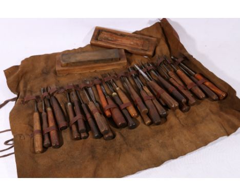 Tool roll containing vintage gouges and a sharpening block.