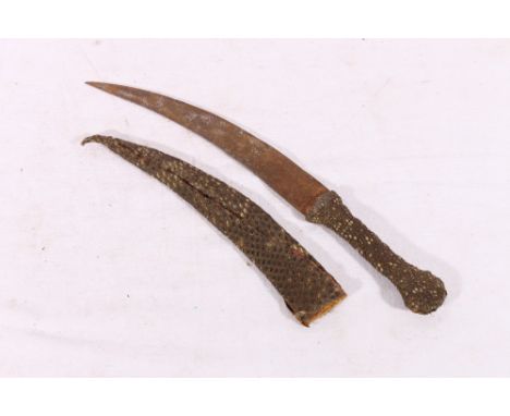 Indian Khanjar type dagger with curving blade with incised decoration, the hilt and scabbard wrapped in reptile skin, blade l