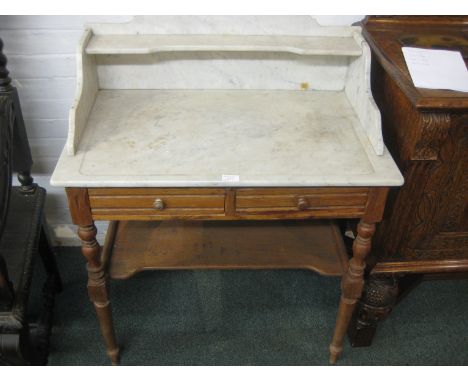 A late Victorian pitch pine two drawer marble top washstand on turned tapering legs, the top has an additional marble single 