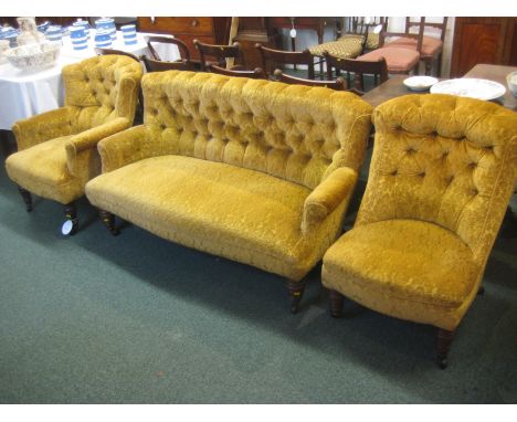 Victorian salon suite in old gold dralon upholstery comprising three-seater button-back settee, button-back armchair and low 