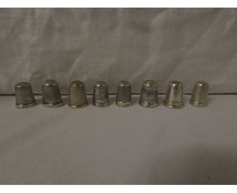 EIGHT SILVER THIMBLES - each with British assay marks for Birmingham and Chester, of which six are dimpled all over, one plai