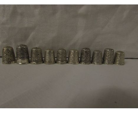 TEN SILVER THIMBLES - each with British assay marks for Birmingham, Chester, London and Sheffield, with all over foliate chas