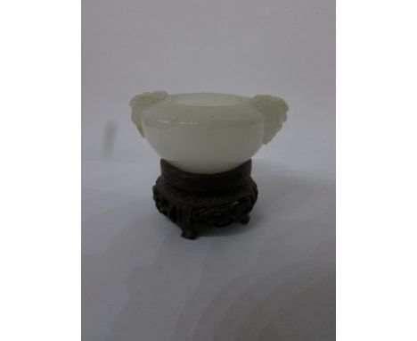 Chinese Peking glass miniature bowl resembling jade, of circular flattened form carved with two mask heads, four character ma