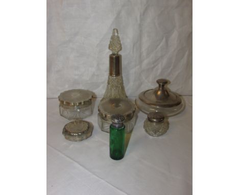 Seven silver and white metal mounted dressing table jars and bottles - a pair of jars with scallop edged, engine turned lids 