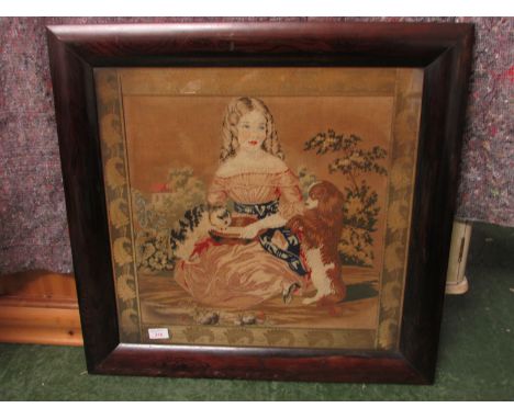 A 19th century tapestry of girl with cat and spaniel within a woven border, glazed and in a faux rosewood frame, 53cm x 54cm