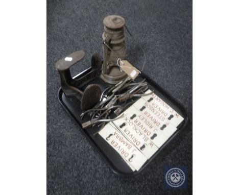 A tray of railway ticket clippers, seven mid 20th century locker plates, cobblers last and oil lamp 