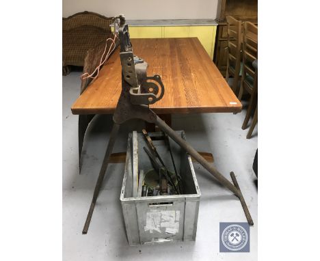 A pipe bender and a crate of hand saws, spirit levels, oil gun, scales etc 