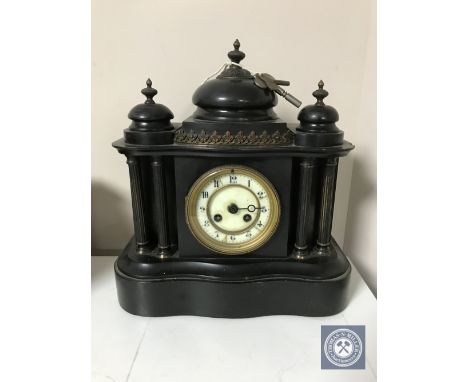 A Victorian black slate mantel clock with enamelled dial 