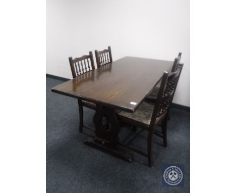 An oak refectory dining table together with a set of four oak tapestry seated dining chairs 