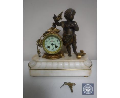 A continental gilt figural mantel clock of a cherub with enamelled dial on marble base 