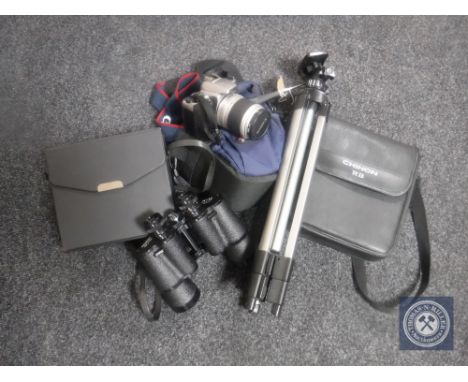 A camera tripod together with a Canon Eos 3000 digital camera in bag and two sets of cased binoculars 
