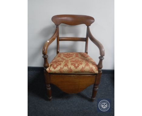 An antique mahogany scroll arm commode chair 