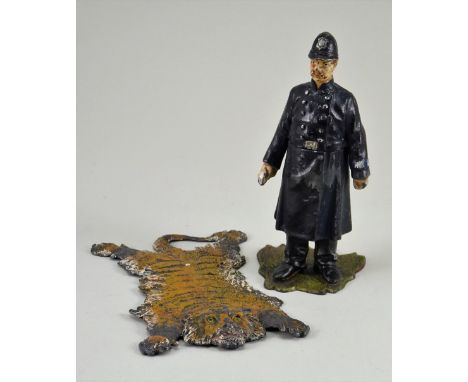 Painted lead Policeman ink well, circa 1900, on green base and hinged at waist with ceramic ink well, 4 ¾” (12cm) tall, toget