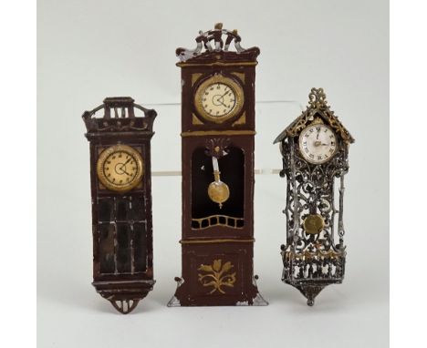 Three miniature wall-clocks for dolls house, German circa 1890, including two brown metal painted clocks with gilt detail, an