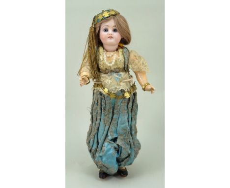 Bisque head ‘walker’ in original Turkish costume, French circa 1910, with fixed blue glass eyes, open mouth with upper teeth 