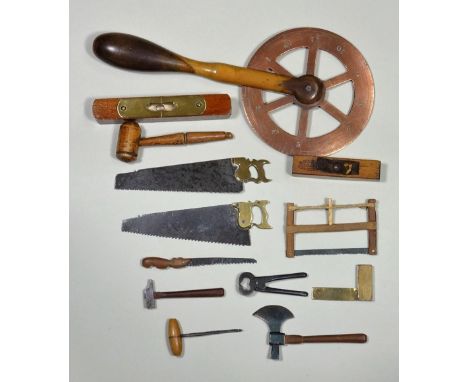 Miniature workshop tools, 19th century, two saws with brass handles, 4 ¼” (11cm) long, wooden Bow saw, pruning saw, hammer, a