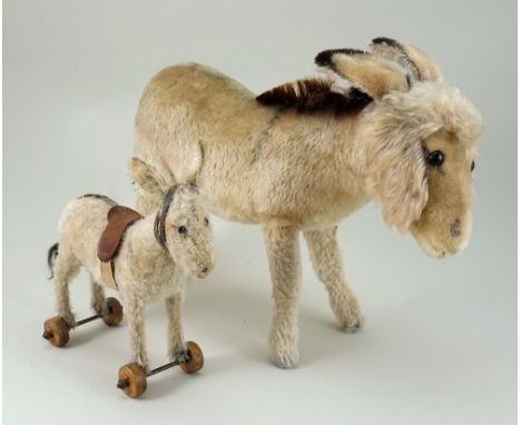 Small Steiff cream mohair Donkey on wheels, German circa 1920, with black button eyes, large ears with button to left ear, pr