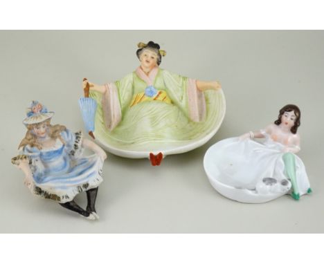 Three Bawdy china naughty novelties flipper trinket dishes, German circa 1905, including a reclining young Lady wearing green