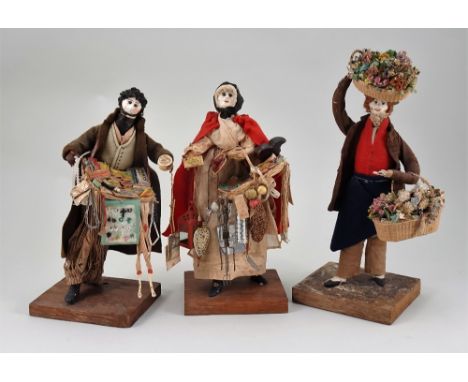 Three early Peddler dolls in glass fronted case, by C&amp;H White, Milton, Portsmouth, 1820s, all standing on a wooden base w