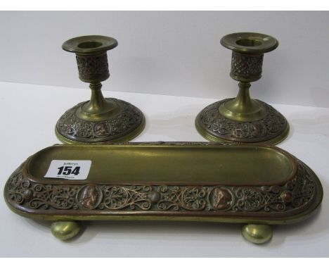 METALWARE, Edwardian brass and copper 3 piece desk set of pen tray and pair of dwarf candlesticks with portrait relief border