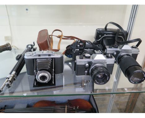 A collection of 35mm cameras to include an Agfa Isolette III, Praktica MTL50, MTL5 and Praktica BMS Electronic and a tripod