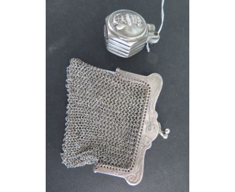 A white metal purse with foliate design to outer, inner with divider with a white metal pocket lighter with Royal Naval emble