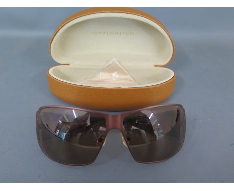 A pair of Tommy Hilfiger sun glasses in their case model/serial no TH7277A BRN-1 6711-25 brown metal and plastic frames in un
