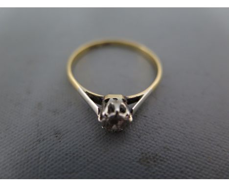 An 18ct yellow gold solitaire ring the approx 0.06ct set in platinum - ring size P - approx weight 1.9 grams