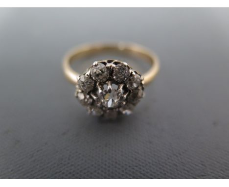 An 18ct yellow gold ring stamped and tested - with white gold overlay ring size S leading to a coronet style setting with nin