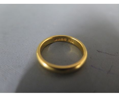 A 22ct gold band ring size K - approx weight 4.5 grams - generally good, some usage