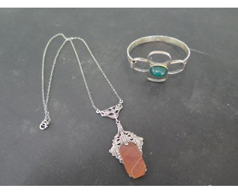 A silver Art Deco style silver pendant on chain and a silver bangle