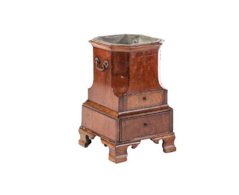 A George II walnut pedestal wine cooler of canted form and fitted two short drawers On moulded and shaped ogee bracket feet.P