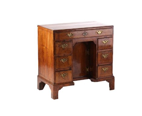 A George II walnut caddy topped lady's kneehole desk, with crossbanded and quarter veneered top above one long frieze drawer 