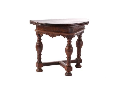 An early 17th-century style oak credence table with demilune fold-over top and spindle supports united by a cross stretcher, 