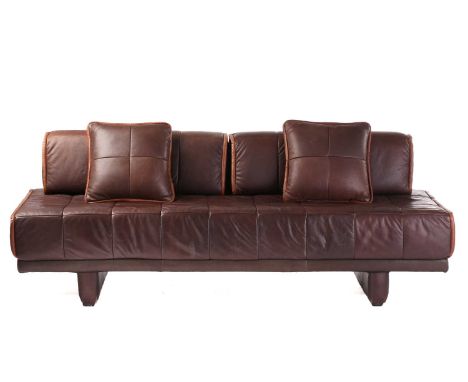 A vintage possibly Danish bronze coloured hide sofa with a patchworked surface with two loose angular bolster cushions piped 