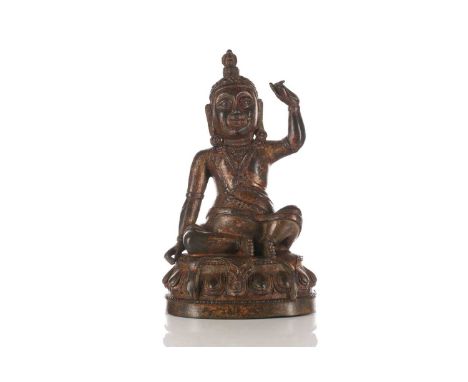 A n Indian gilt-bronze figure of Milarepa (?) seated in Lila asana upon an animal pelt on a single lotus socle. 15 cm long x 