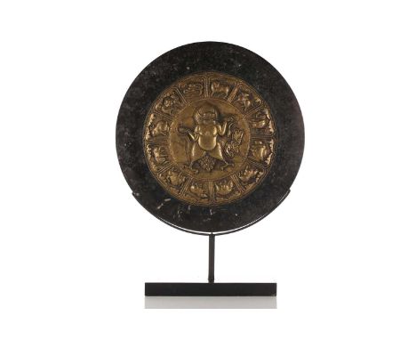 A large Tibetan style hardstone Bi disk with applied bronze boss embossed with zodiac symbols and a central reserve with the 